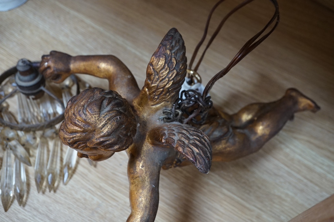 A pair of gilt twin branch cherub chandeliers with glass drops. Condition - some losses